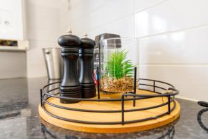 a terrarium with a plant in a glass jar on a table at Central Home in Milton Keynes in Milton Keynes