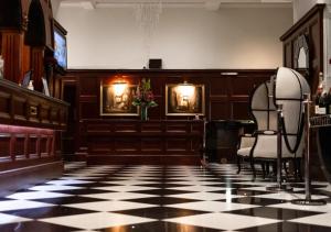 a court room with chairs and a checkered floor at Atlantic Hotel Newquay in Newquay