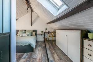 a bedroom with a bed and a skylight at Le 27 - Crécy La Chapelle - Disney 15min in Crecy la Chapelle