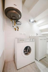 a washer and dryer in a white laundry room at Casa Quattordici in Cesena