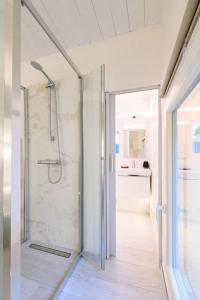 a bathroom with a shower with a glass door at Casa Quattordici in Cesena +21 photos