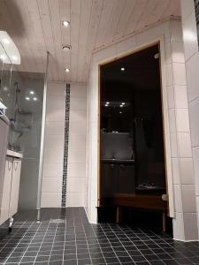 a bathroom with a shower and a glass door at Ruka Cottage in Kuusamo