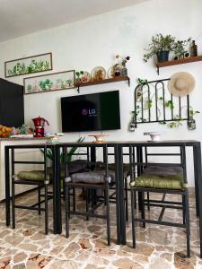 a desk with chairs and a computer monitor on a wall at Le Gorgoni b&b in Syracuse