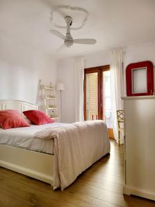 a bedroom with a bed with red pillows and a television at Jaime III - Palma center - Luxury Suites in Palma de Mallorca