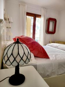 a bedroom with a bed and a lamp on a table at Jaime III - Palma center - Luxury Suites in Palma de Mallorca