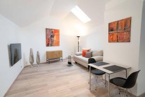 a living room with a couch and a table at NEW modernes Loft im Zentrum von Deggendorf in Deggendorf