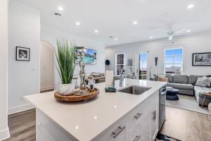 a kitchen with a sink and a living room at Spanish Dagger Serenity in Port Aransas