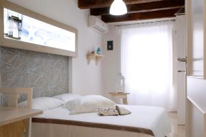 a bedroom with a bed with two shoes on it at Appartamento Alla Corte dei Misteri in Trapani