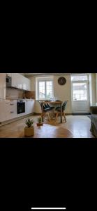 a kitchen with a table and chairs in a room at « Le Clos de la Côte d’Or » in Ladoix Serrigny