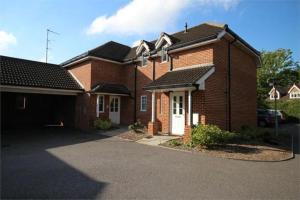 a brick house with a driveway in front of it at Travaal.©om - 2 Bedroom Apartment - Farnborough in Farnborough