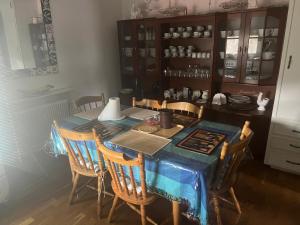 a dining room table with a blue table cloth on it at Stop at The Cross in Borås