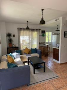 a living room with a couch and a table at Caños de Meca, Luz de Luna in Los Caños de Meca