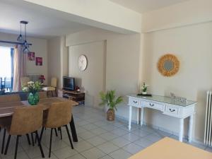 a living room with a table and a dining room at Nefeli's Home- Family luxury apartment in Heraklio Town