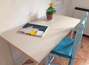 a book on a table with a plant on it at ALOJAMIENTO NO ACTIVo in Moclín