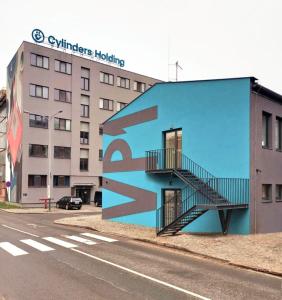 a blue building with a staircase on the side of it at Hotel VP1 in Ostrava