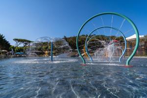 a water park with a water slide in the water at Stella del Mare Family Camping Village in Castiglione della Pescaia