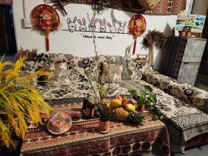 a couch with a table with fruits on it at TiTi House in Dồng Văn +67 photos