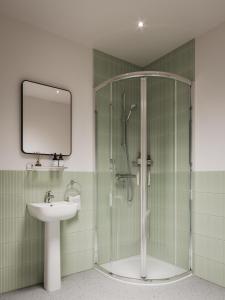 a bathroom with a shower and a sink and a mirror at Bob W St Paul's in London