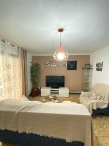 a living room with a bed and a tv at Apartamento Turístico en el centro in Tarragona