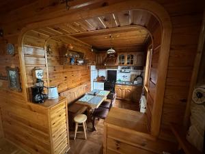 a kitchen and dining room in a log cabin at Oaza spokoju - Szczyrk - Spacerowa 32 in Szczyrk