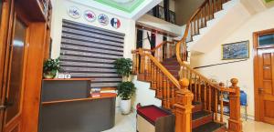 a hallway with wooden stairs in a house at Đăng Dương Motel in Sapa +54 photos