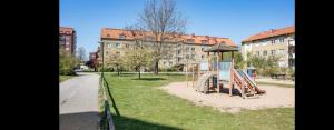 a playground in a park in front of a building at 2 bedroom apartment close to Eurovision in Malmö