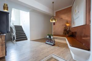 a living room with a table and a staircase at Milling Hotel Mini 19 in Odense