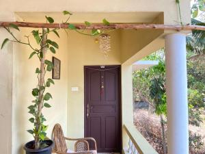 a entrance to a house with a purple door at Mango Villa in Varkala