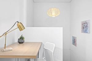 a desk with a lamp and a chair in a room at NEW 3BR Apt in Kingsgrove Sleeps 7 in Sydney