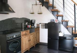a kitchen with a stove and a refrigerator at Türmle in Öhningen