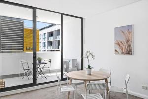 a dining room with a table and chairs at NEW 3BR Apt in Kingsgrove Sleeps 7 in Sydney