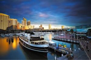 a large boat docked at a marina in a city at NEW 3BR Apt in Kingsgrove Sleeps 7 in Sydney