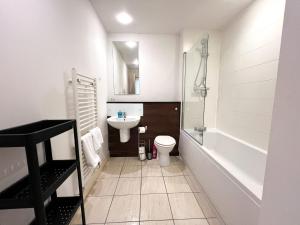 a bathroom with a sink and a toilet and a shower at Central Gem 1 Bed Flat City Centre in Glasgow