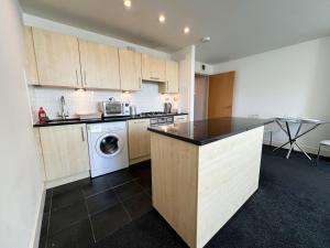 a kitchen with a washer and dryer in it at Central Gem 1 Bed Flat City Centre in Glasgow