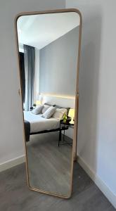 a large mirror in a bedroom with a bed at Centric 3ºI in Madrid