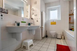 a white bathroom with a sink and a toilet at Ferienwohnung Glückauf in Castrop-Rauxel +13 photos