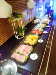 a buffet line with many different types of food at Hotel Martina in Żnin