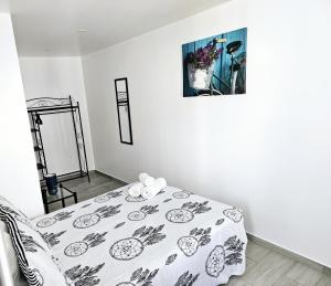 a white room with a bed with a blanket at Casa D´Aldeia - Carrapateira in Aljezur