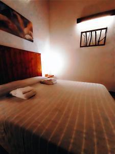 a bedroom with a bed with a light on it at Polani - Il Noceto in Cave