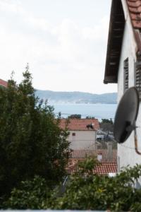 a view of the ocean from a house with a mirror at Apartment MM in Sukošan