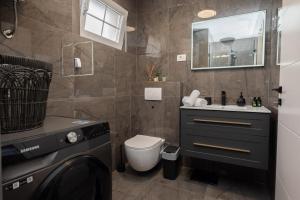 a bathroom with a toilet and a sink at Apartment MM in Sukošan +24 photos