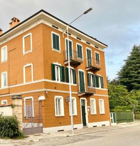 a building with a street light in front of it at Palazzo Proietti 6 in Biella