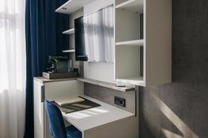 a kitchen with a counter with a sink at Homaris East Side - Self-Check In in Berlin +104 photos