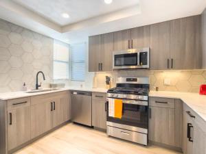 a kitchen with a stainless steel stove and microwave at CozySuites Oasis at Kierland Commons in Scottsdale