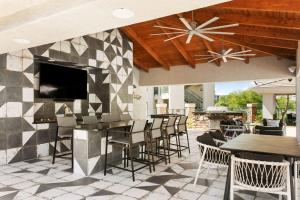 a patio with tables and chairs and a fireplace at CozySuites Oasis at Kierland Commons in Scottsdale