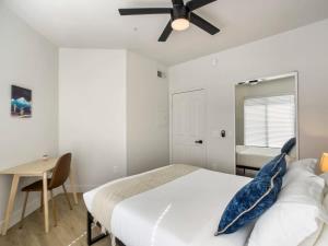 a bedroom with a bed and a desk and a ceiling fan at 2BR Kierland Commons Golf Oasis by CozySuites! in Scottsdale