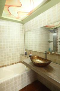 a bathroom with a sink and a bath tub at CORAL VILLA in Lonavala