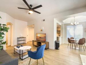 a living room with a tv and a table and chairs at 2BR Kierland Commons CozySuites by the golf course in Scottsdale