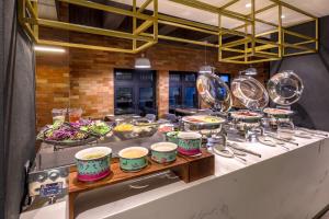 a buffet line with bowls and plates of food at Santa Grand Classic Kuala Lumpur, Chinatown in Kuala Lumpur