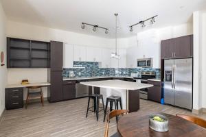 a large kitchen with a table and some chairs at TWO Luxury CozySuites on the Town Lake waterfront 4&5 in Tempe
